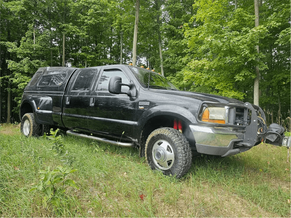 Black Ford Super Duty dually with camper shell