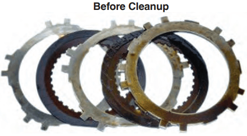 Automatic transmission clutch plates pre-cleanup. Varnish and glazing is heavy on some of the plates.