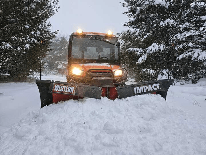 My Kubota RTV Diesel w/Western Impact V-Plows staying clean with Mudslinger